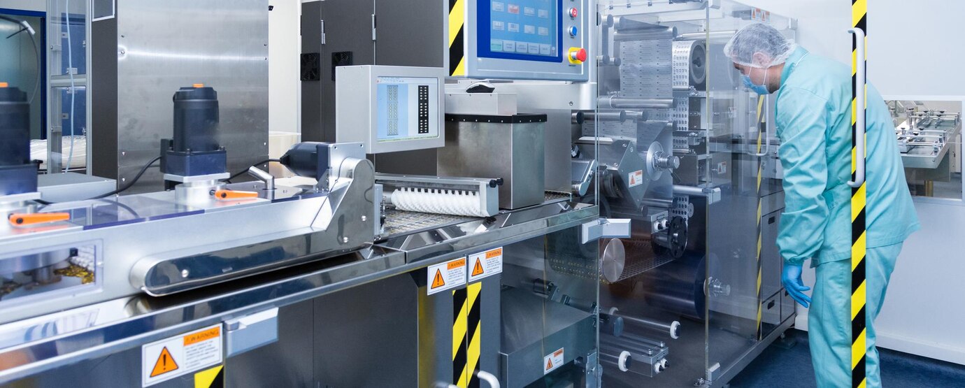 pharmacy-industry-factory-man-worker-protective-clothing-sterile-working-conditions-operating-pharmaceutical-equipment_645730-446.jpg